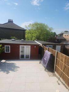 a patio in front of a house with a fence at Hideaway Retreat 1 & 2 in Belvedere