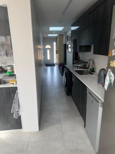 a kitchen with black cabinets and a tile floor at Hideaway Retreat 1 & 2 in Belvedere +9 photos