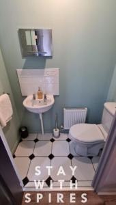 a small bathroom with a sink and a toilet at The Farrier's recently refurbished 3 bedroom comfy and cosy bolt hole close to Cannock town centre in Hednesford +39 photos