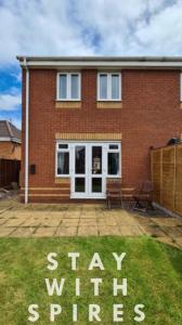 a brick house with a sign that says stay stirred at The Farrier's recently refurbished 3 bedroom comfy and cosy bolt hole close to Cannock town centre in Hednesford