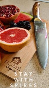a cutting board with a slice of grapefruit and a knife at The Farrier's recently refurbished 3 bedroom comfy and cosy bolt hole close to Cannock town centre in Hednesford