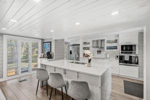 a kitchen with white cabinets and a kitchen island with chairs at 1055 Shady Lane in Merritt Island