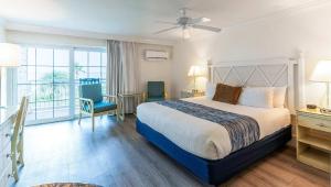 a hotel room with a bed and a balcony at Tween Waters Island Resort & Spa in Captiva +21 photos