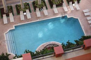 a large swimming pool on the side of a building at Sea Gardens Resort Studio Suite in Pompano Beach