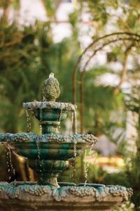 a green fountain with a bird sitting on top at Sea Gardens Resort Studio Suite in Pompano Beach +14 photos