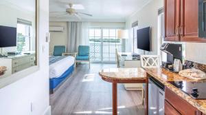 a hotel room with a bedroom with a bed and a desk at Tween Waters Island Resort & Spa in Captiva