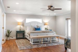 a bedroom with a bed and a ceiling fan at 1480 W Riviera Dr in Merritt Island