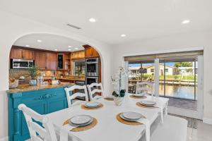 a kitchen and dining room with a white table and chairs at 1480 W Riviera Dr in Merritt Island +43 photos