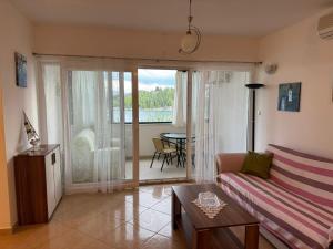 a living room with a couch and a table at 2 bed Comfy Gem: Functional, Ideal Location, Steps to the Beach in Blace