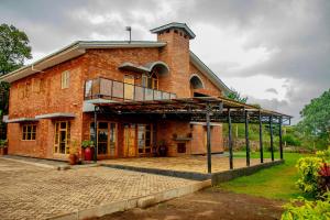 a large brick building with a balcony on it at Tranquil Hillhouse in Nkoanrua