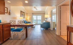 a kitchen and living room with a table and chairs at Tween Waters Island Resort & Spa in Captiva