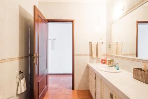 a bathroom with a sink and a mirror at Ben House, private parking in Ponta Delgada