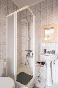 a white bathroom with a shower and a sink at Ben House, private parking in Ponta Delgada