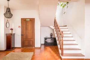 a staircase in a home with white walls and wooden floors at Ben House, private parking in Ponta Delgada +43 photos