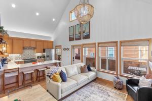 a living room with a couch and a kitchen at Stella del Mare in Dover ID in Dover