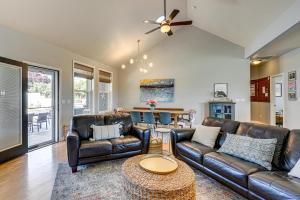 a living room with leather furniture and a ceiling fan at Hot Tub & Seasonal Pool: Remarkable Yakima Getaway in Yakima