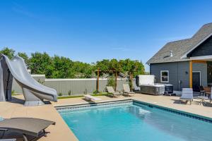 a swimming pool with a slide next to a house at Hot Tub & Seasonal Pool: Remarkable Yakima Getaway in Yakima