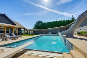 a swimming pool with a slide in a house at Hot Tub & Seasonal Pool: Remarkable Yakima Getaway in Yakima