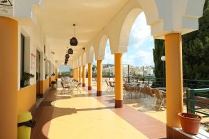 a hallway with tables and chairs on a balcony at Rialgarve in Faro