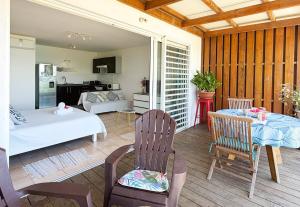 a living room with a bed and a table and chairs at Breathtaking Bora Bora Lagoon View Studio in Bora Bora