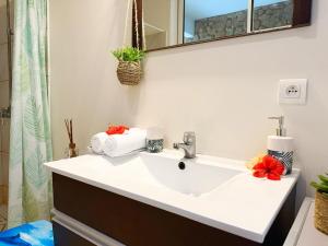a bathroom with a white sink and a mirror at Breathtaking Bora Bora Lagoon View Studio in Bora Bora +37 photos