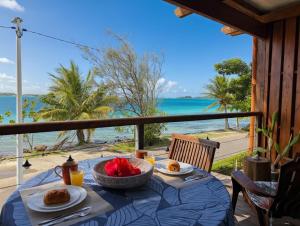 a table with food and a view of the ocean at Breathtaking Bora Bora Lagoon View Studio in Bora Bora
