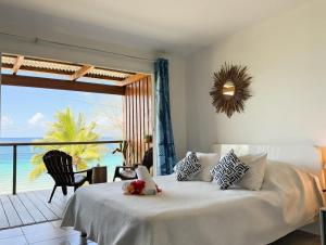 a bedroom with a bed with a view of the ocean at Breathtaking Bora Bora Lagoon View Studio in Bora Bora