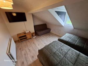 an attic room with a bed and a couch at Hanna house in Belfast