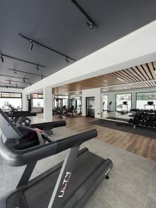 a gym with treadmills and ellipticals in a room at Luxueux T2 à Ain Zaghouen in El Aouina