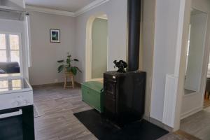 a living room with a tv in a room at Cozy forest cabin in Vik