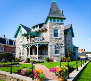 a large stone house with a turret at Willough Bed and Breakfast in Conshohocken