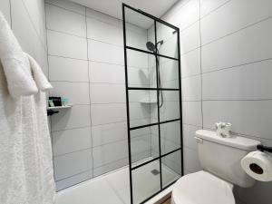 a bathroom with a toilet and a shower at Mainstay Inn in Phoenixville +36 photos