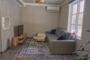 a living room with a couch and a tv at Cozy forest cabin in Vik