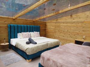 a bedroom with two beds in a room with wooden walls at Sirio in San Francisco