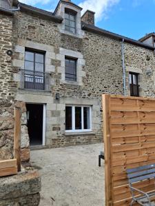 a stone house with a gate in front of it at la clé de la rance in Plouër-sur-Rance