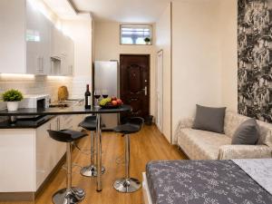 a kitchen and living room with a couch and a table at Old Tbilisi Georgian Soul in Tbilisi City