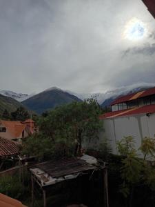 a view of a mountain from a house at Mrs Sapo Chalets in Urubamba