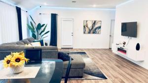 a living room with a couch and a table at Luxe Haven in Richmond