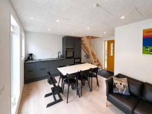 a kitchen and dining room with a table and chairs at Hvanngarðs Smáttan by Stóra in Dalur