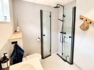 a bathroom with a shower with a glass door at Hvanngarðs Smáttan by Stóra in Dalur +16 photos