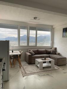 a living room with a couch and a table at Piad Apartman in Bar