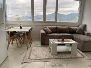 a living room with a couch and a table at Piad Apartman in Bar