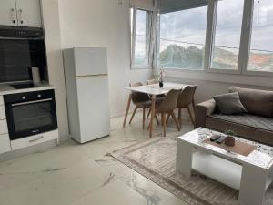a living room with a couch and a table at Piad Apartman in Bar