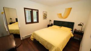 a bedroom with two beds and a mirror at Nemandua Catskills: Hot Tub+Fire Pit+Pool Table+EV in Lanesville +16 photos