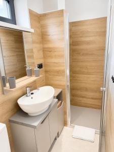 a bathroom with a sink and a shower at M3-Apartmány in Martin