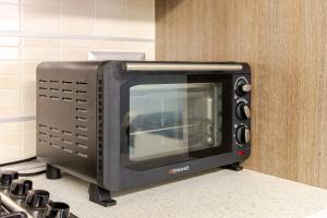 a microwave sitting on a counter next to a stove at Sea 150mt - Il Vicolo di Cetara in Cetara