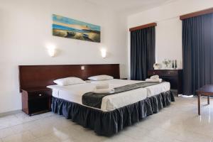 a bedroom with a large bed in a room at Windmills Hotel Apartments in Protaras