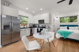 a kitchen and a bedroom with a bed and a table at Irie Vibes Private Guest House Downtown in Raleigh