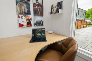 a desk with a laptop sitting on top of it at Irie Vibes Private Guest House Downtown in Raleigh +16 photos