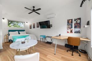 a bedroom with a bed and a desk and a table at Irie Vibes Private Guest House Downtown in Raleigh